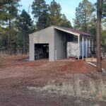 Modern galvanized steel cabins in Fortuna Foothills, Arizona, showcasing durability and contemporary design against a scenic backdrop